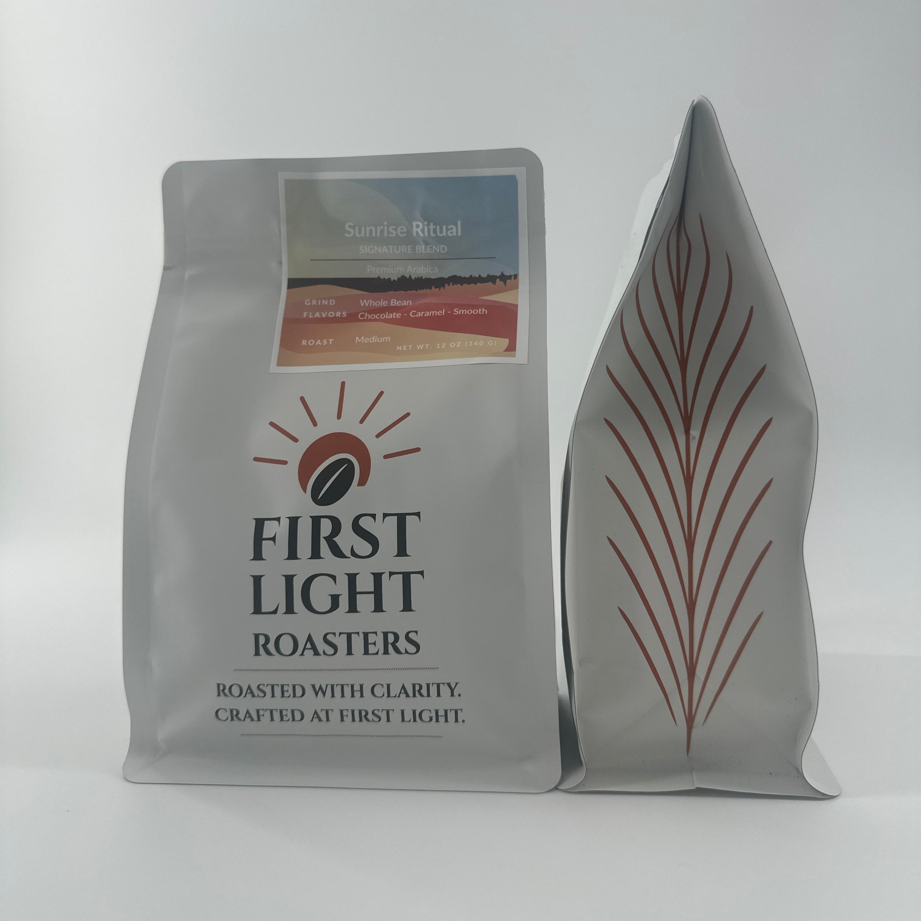 Two First Light Roasters coffee bags on a white background