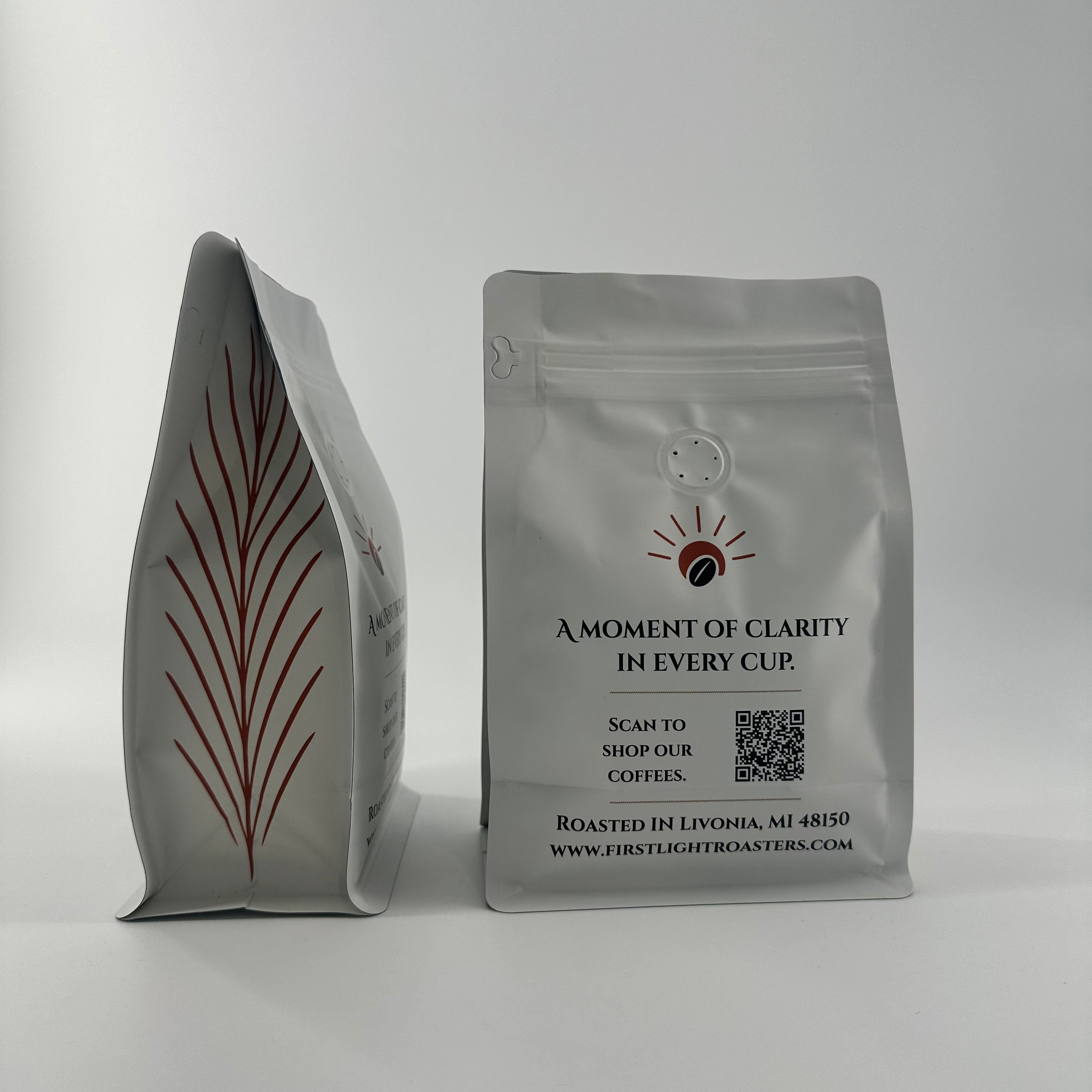 Two coffee bags with branding and text on a white background