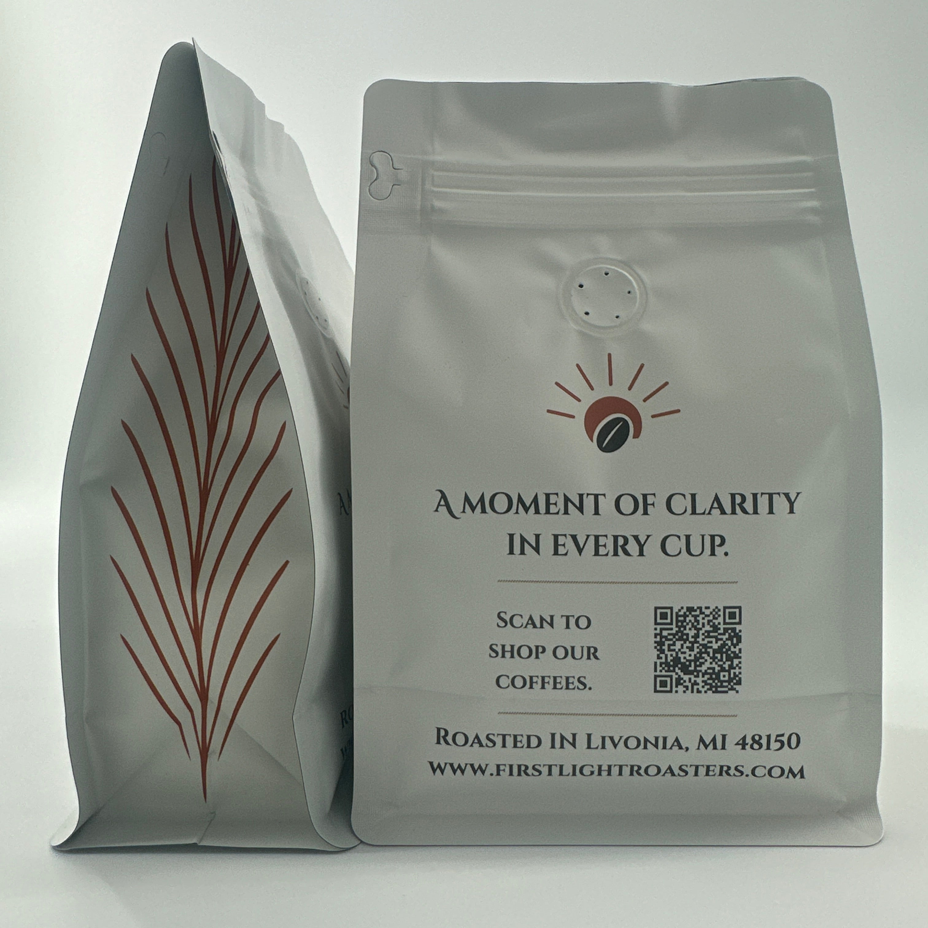 Two gray coffee bags with branding and text on a white background