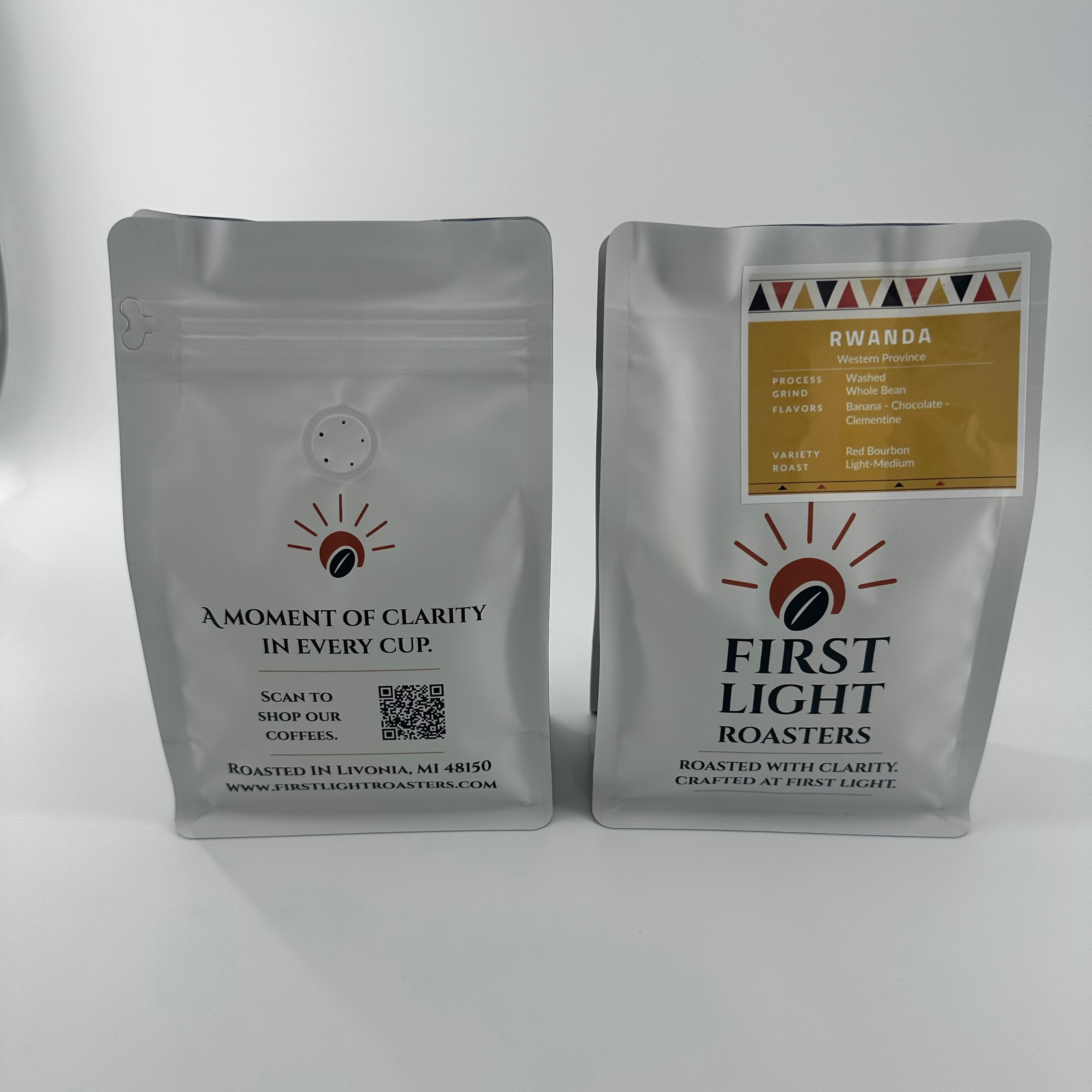 Two coffee bags from First Light Roasters on a white background